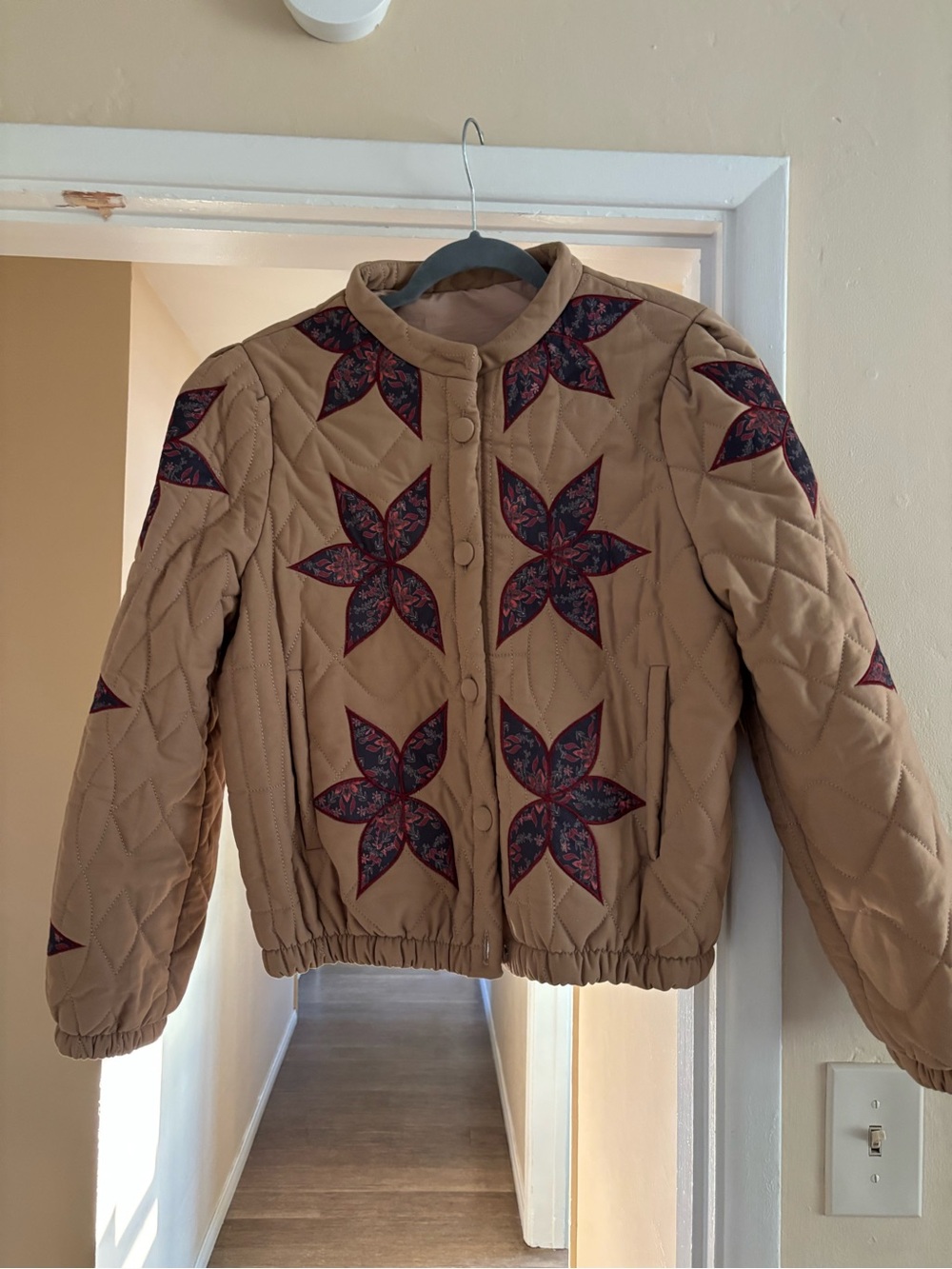 Tan quilted jacket with patchwork floral pattern